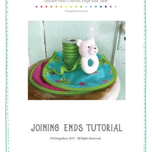 May include: A green, blue, and pink baby bib with a white teddy bear and a teething ring. The bib is trimmed with green crochet edge bias tape. "Joining Ends Tutorial" and "Vintagedoor 2017. All Rights Reserved." are printed on the image.
