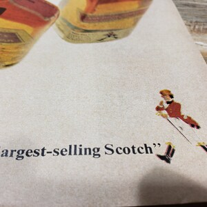 May include: A vintage advertisement for a brand of Scotch whisky. The ad features a man in a red jacket and white pants walking with a walking stick. The text on the ad reads "World's largest-selling Scotch".