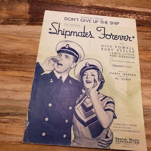 May include: A vintage sheet music cover for the song "Shipmates Forever" from the movie "Don't Give Up the Ship". The cover features a black and white photo of a man and woman in naval uniforms, with the title of the song and movie printed in large, bold letters.
