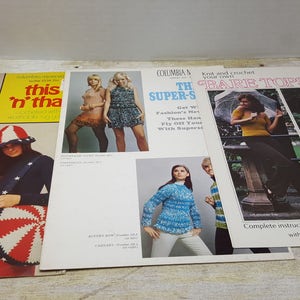 May include: A collection of vintage crochet pattern books featuring various designs, including a red and black bag, a rainbow striped bag, a white and red striped bag, and a blue and white striped top. The book covers feature images of women wearing the crocheted items.