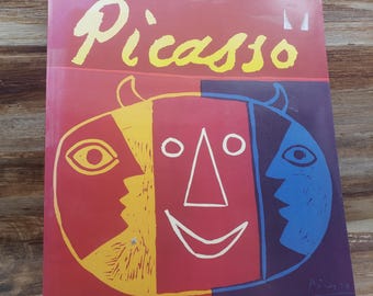 May include: A colorful book cover featuring a red, yellow, blue, and white abstract face with the word "Picasso" in yellow lettering.