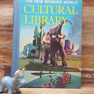 May include: A vintage book titled "The New Wonder World Cultural Library" with a blue cover and a colorful illustration of an elephant, trees, and a desert landscape.