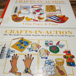 May include: Two vintage craft books with the title "Crafts-In-Action" and the subtitle "The Marshall Cavendish Step-by-Step Guide to Craft Projects". The covers feature colorful illustrations of craft projects.