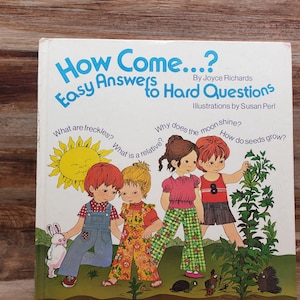 May include: A book cover with the title "How Come...? Easy Answers to Hard Questions" by Joyce Richards. The cover features illustrations of children asking questions about nature, such as "What are freckles?", "Why does the moon shine?", "What is a relative?", and "How do seeds grow?"