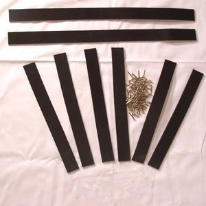 May include: A set of black rubber weather stripping for doors and windows, with a pile of small silver nails.