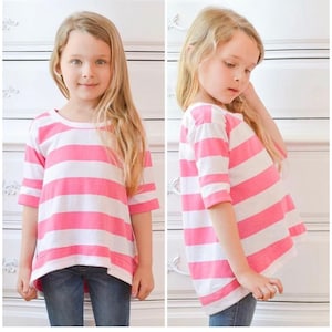May include: A pink and white striped long-sleeve shirt with a rounded neckline. The shirt has a longer back hem than the front hem.