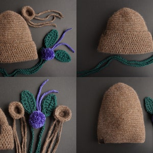 May include: A collection of handmade crochet hats in various stages of completion. The hats are brown with ear details. Accompanying the hats are green leaves, purple pom-poms, and long brown yarn strands. The items are arranged on a dark gray surface.