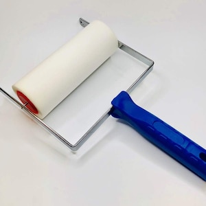 May include: A white foam roller with a blue handle and a metal frame. The roller is attached to the frame with a red pin.