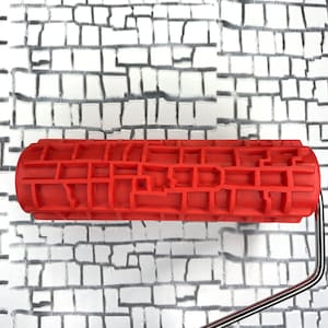 May include: Red rubber roller with a brick pattern for creating a brick wall effect on a surface. The roller is attached to a metal handle.