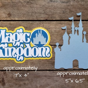 May include: A blue and yellow paper cutout of the Magic Kingdom logo with a silhouette of Cinderella's Castle. The logo measures approximately 7 inches by 4 inches. The castle silhouette measures approximately 5 inches by 6.5 inches.