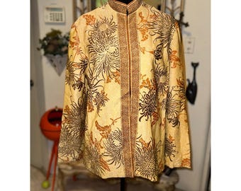 May include: A long-sleeved jacket in a light gold hue featuring a dark brown floral pattern of chrysanthemums. The garment has a mandarin collar and a vertical front placket decorated with a repeating geometric Greek key border design.