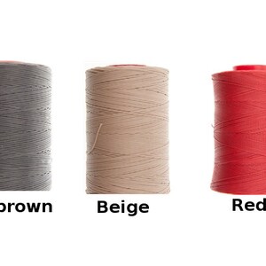May include: Three spools of waxed thread for leather crafting. The spools are dark brown, beige, and red.