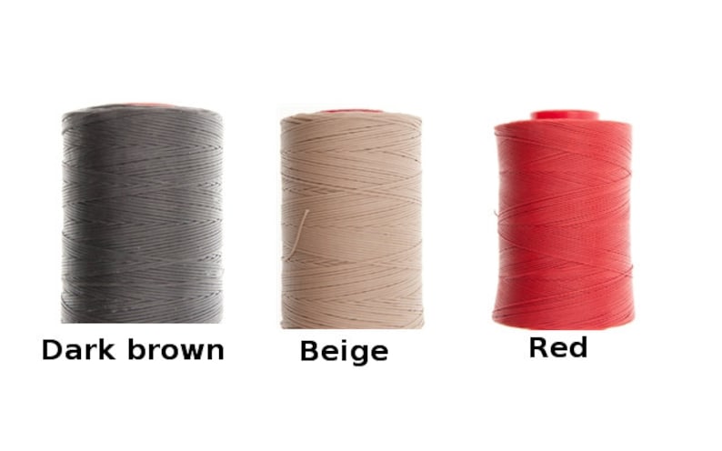 May include: Three spools of waxed thread for leather crafting. The spools are dark brown, beige, and red.