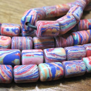 May include: A strand of colorful, multi-colored, striped, and patterned beads. The beads are made of a material that resembles stone or ceramic. The beads are all different colors, including blue, pink, red, and green.