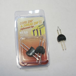 May include: Three replacement tips for the Cord Zap & Thread Zap II by The Bead Smith. The tips are silver with black plastic ends.