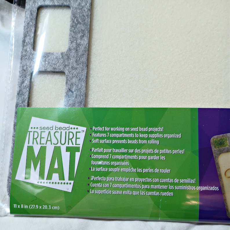 May include: Gray seed bead mat with seven compartments to keep supplies organized. The mat is 11 inches by 8 inches and has a soft surface to prevent beads from rolling.