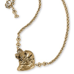 May include: A gold-colored necklace featuring a detailed pendant of a dog's head. The necklace has a delicate chain with a lobster clasp closure and a small bone charm. The dog pendant is intricately designed, showcasing the dog's features.