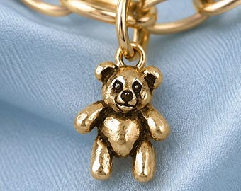 May include: A gold-toned metal teddy bear charm featuring a textured finish and a small jump ring for attachment. The charm is suspended from a gold-toned oval link chain. The text at the bottom of the image states: Chain Sold Separately.