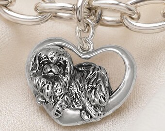 May include: A silver-toned metal charm in the shape of a heart featuring a detailed relief of a long-haired dog breed, attached to a silver-toned link chain. The text Chain Sold Separately is printed at the bottom of the image.