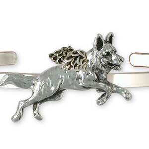 May include: A silver charm bracelet with a German Shepherd dog charm. The dog is depicted with wings and is running. The charm is made of pewter and has a silver finish.