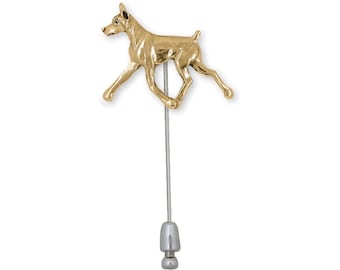 May include: Gold-toned Doberman Pinscher lapel pin with a silver-toned pin back.