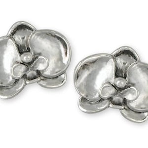 May include: A pair of silver orchid flower stud earrings. The earrings are made of sterling silver and feature a detailed design of an orchid flower.