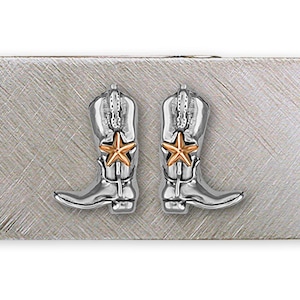 May include: Silver money clip with two silver cowboy boots with a gold star on each boot.