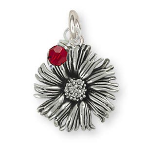 May include: A silver charm in the shape of a flower with a red crystal accent. The flower has a detailed, textured design.