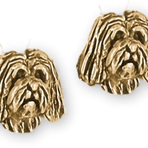 May include: Gold-tone earrings featuring a detailed sculpted design of a Shih Tzu dog's head.