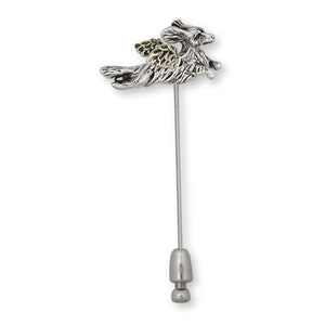 May include: Silver lapel pin featuring a stylized dog with wings. The dog is in flight and has gold accents on the wings.