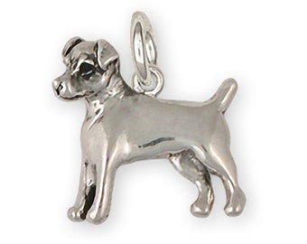 May include: Silver charm of a Jack Russell Terrier dog. The charm is detailed and shows the dog standing with its tail up.