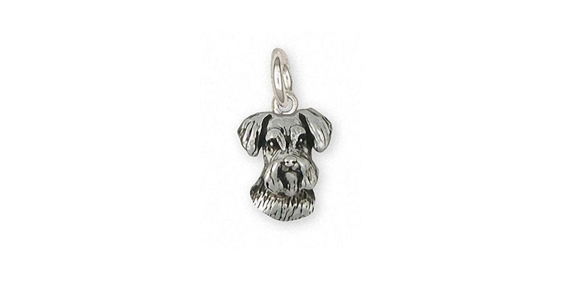 May include: A silver charm in the shape of a miniature Schnauzer dog's head.