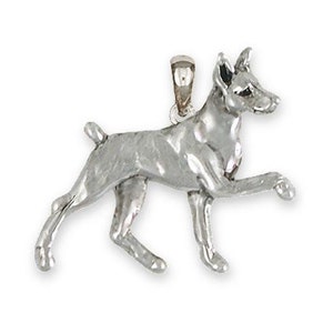 May include: A silver Doberman Pinscher dog charm pendant. The charm is detailed and shows the dog in a walking pose.
