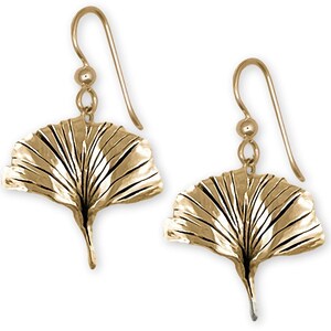 May include: A pair of gold-tone ginkgo leaf dangle earrings. The leaves are detailed and textured.