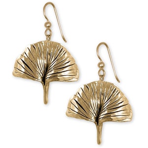 May include: Gold-tone ginkgo leaf dangle earrings. The leaves are textured and have a detailed vein pattern.