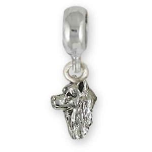 May include: A silver-colored charm featuring a detailed dog head pendant. The charm has a loop at the top for easy attachment to a bracelet or necklace. The dog's features are clearly defined, showcasing its fur and facial structure.