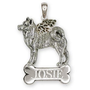 May include: A silver pendant featuring a dog with wings, standing on a bone-shaped tag. The tag is engraved with the name "JOSIE". The pendant has a loop at the top for a chain.