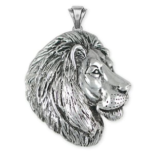 May include: Silver pendant featuring a detailed lion head profile. The lion's mane is intricately sculpted and the pendant has a polished finish.