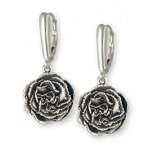 May include: Silver dangle earrings featuring a detailed rose design. The earrings have a leverback closure.