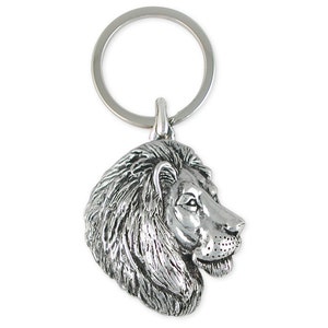 May include: Silver-toned lion head keychain. The lion's head is facing to the right and has a detailed mane.