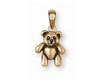 May include: A gold-coloured teddy bear pendant. The pendant features a small, detailed bear with a loop at the top for a chain. The bear has small ears, a smiling face, and outstretched arms and legs. The pendant is approximately 2.5 cm tall.