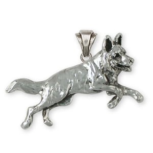 May include: A silver pendant charm of a German Shepherd dog jumping in mid-air.