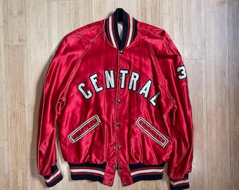 May include: Red satin varsity jacket with "CENTRAL" embroidered in white on the front and the number "3" on the right sleeve.