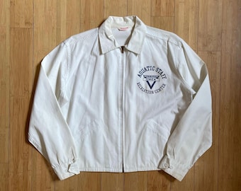 May include: White zip-up jacket with a blue embroidered logo that says "Aquatic Staff, Wheeling YMCA Recreation Centre".
