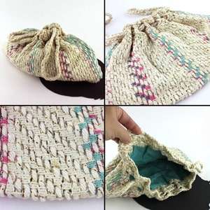 May include: A white crocheted drawstring bag with pink, blue, and gold accents. The bag is made of a woven material and has a soft, textured feel.