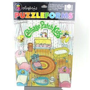 May include: A 30-piece puzzle featuring a colourful illustration of a Cabbage Patch Kid's nursery. The puzzle pieces are designed to stick together like magic. The puzzle is recommended for ages 3 and up.