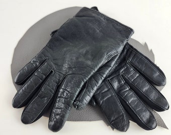 May include: A pair of black leather gloves with a textured surface.