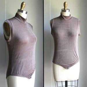 Taupe Sleeveless Stretchy Bodysuit with Mock Turtleneck with snap closure