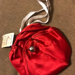 1980’s Frederick’s of Hollywood Shiny Red Thong with Bell. New, tag still attached