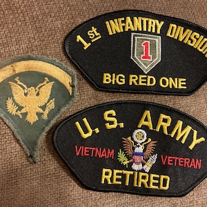 May include: Three embroidered patches. The first is a green patch with a gold eagle and the words "1st Infantry Division Big Red One". The second is a black patch with the words "U.S. Army Vietnam Veteran Retired". The third is a green patch with a gold eagle.